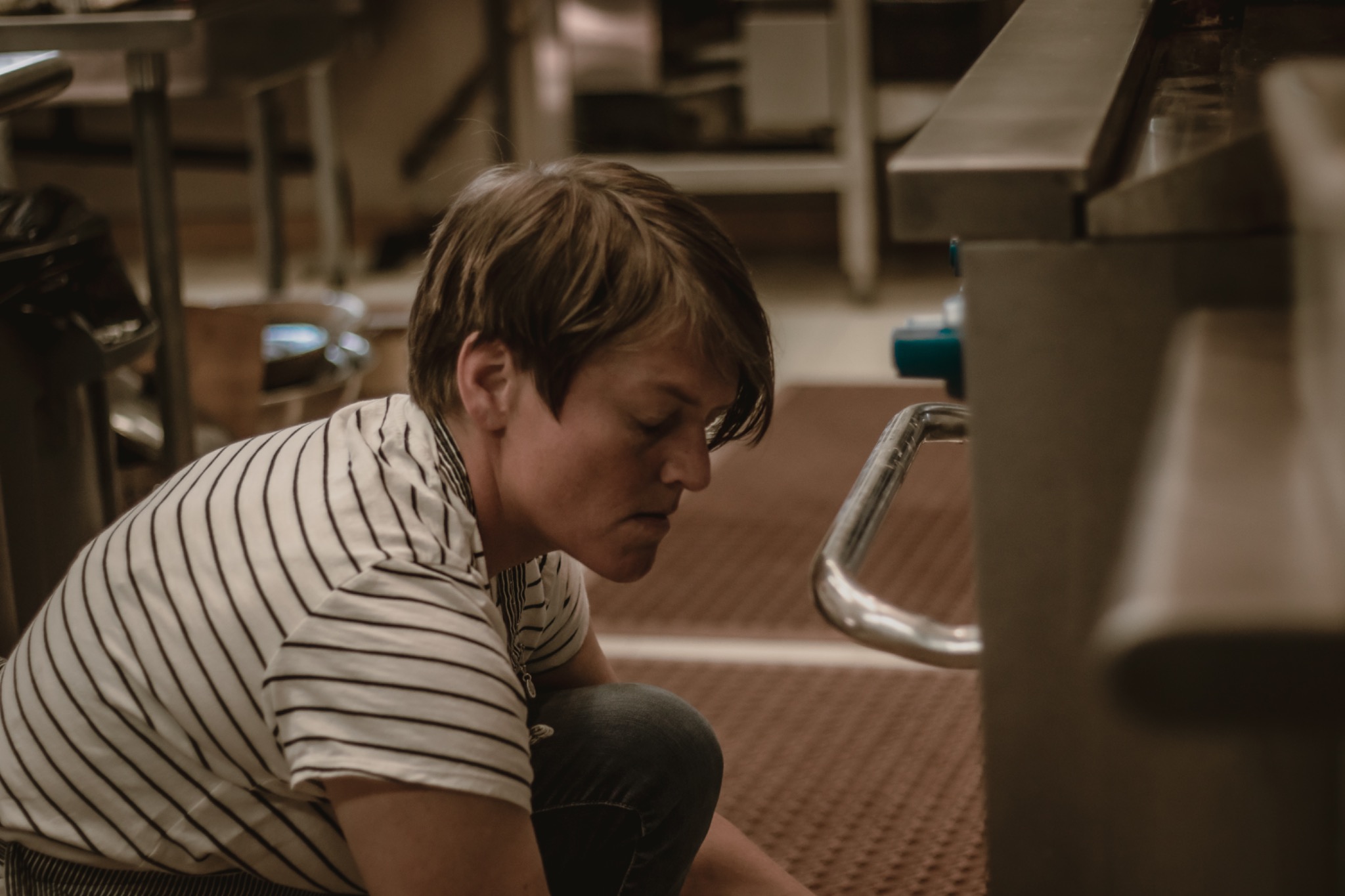 A ceramic artist absorbed in work on the studio floor