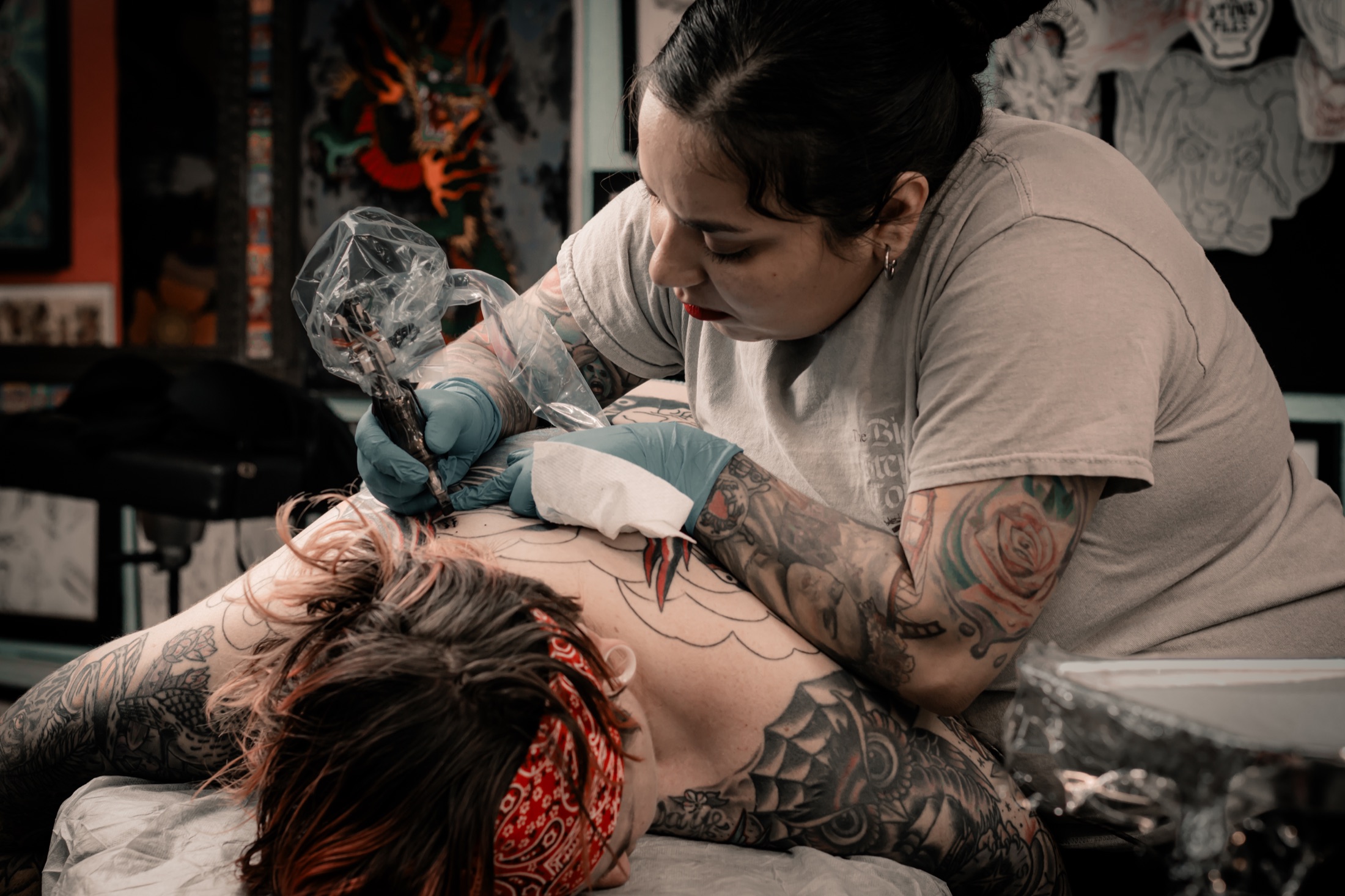 Tattoo artist Christina working with a client at Sublime Tattoo in Tucson